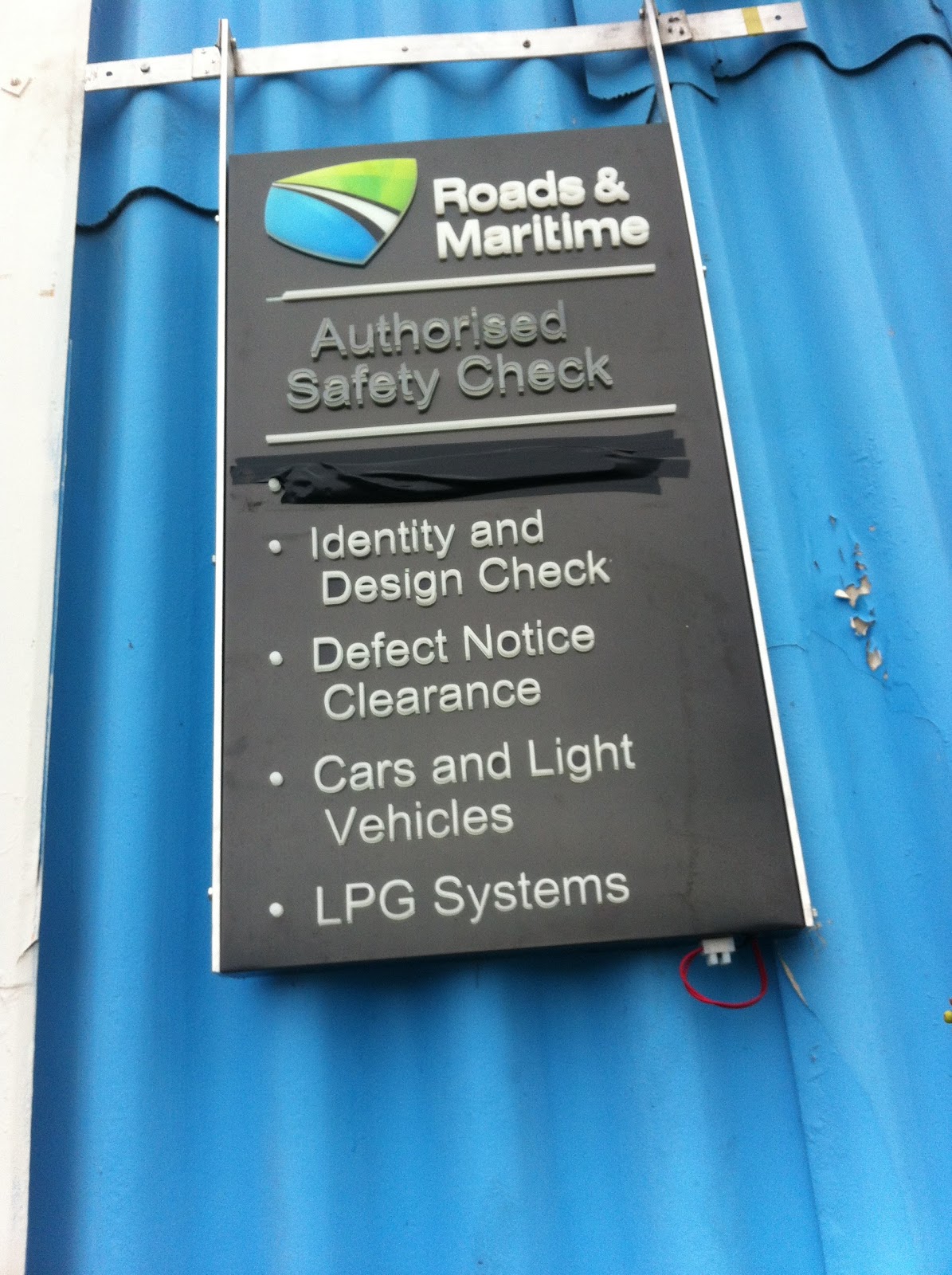 Roads and Maritime Authorised Safety Check sign on the workshop wall